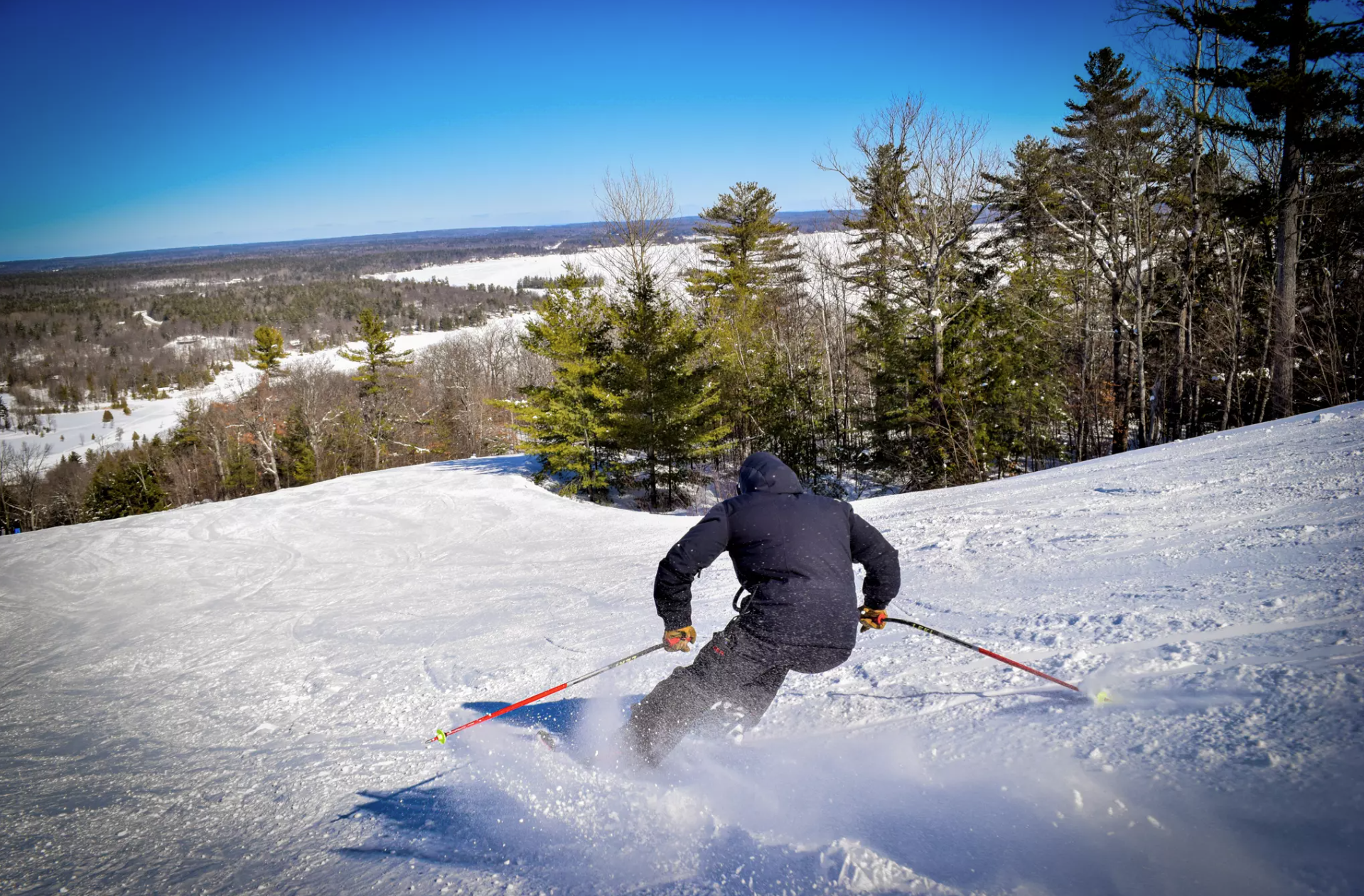 A person skiing down a hill.