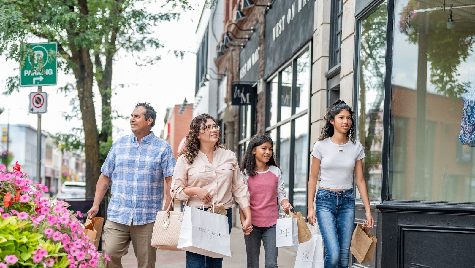 A family walking in downtown Pembroke in summer.