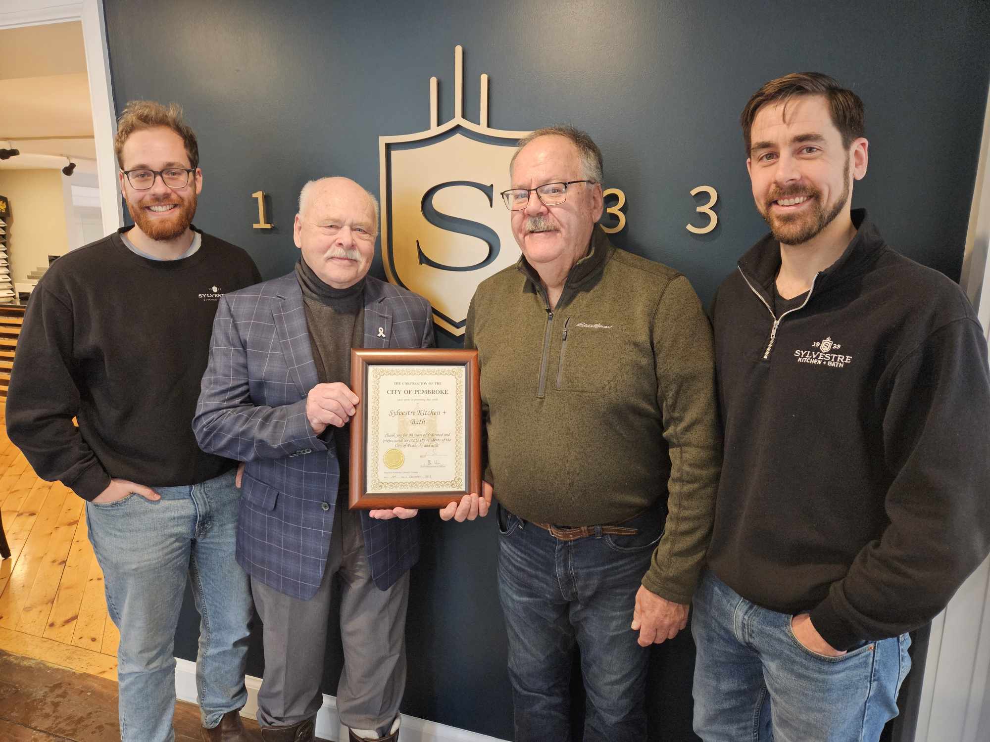 A row of people with a certificate.