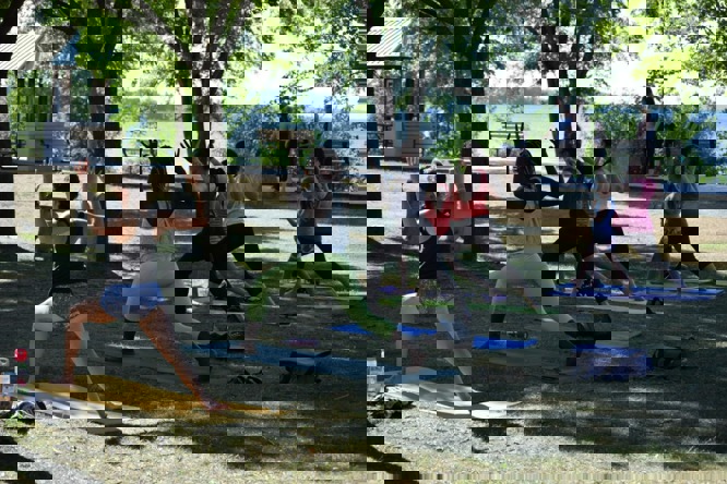 Women doing yoga in a park.