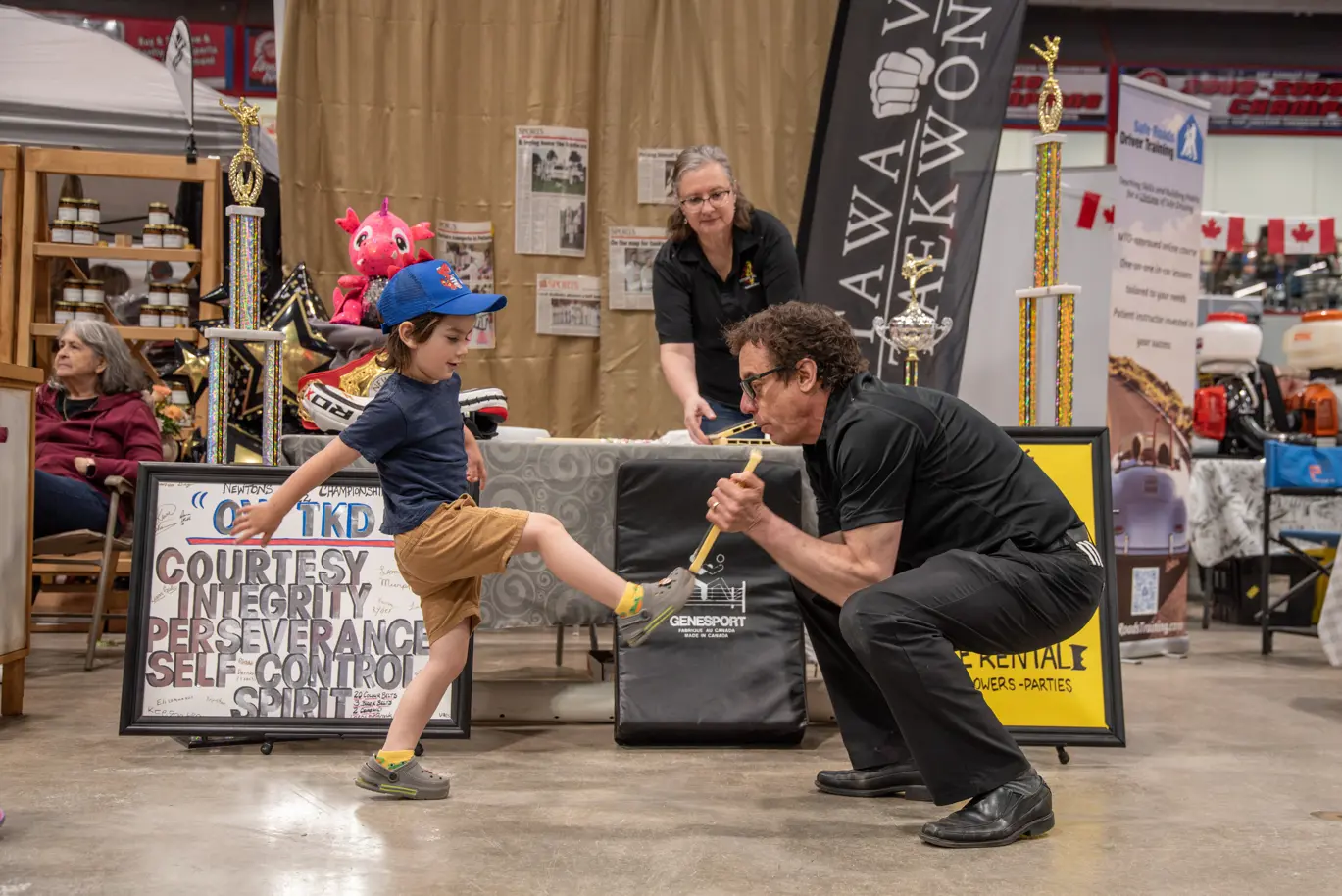 A child kicking a martial arts board.