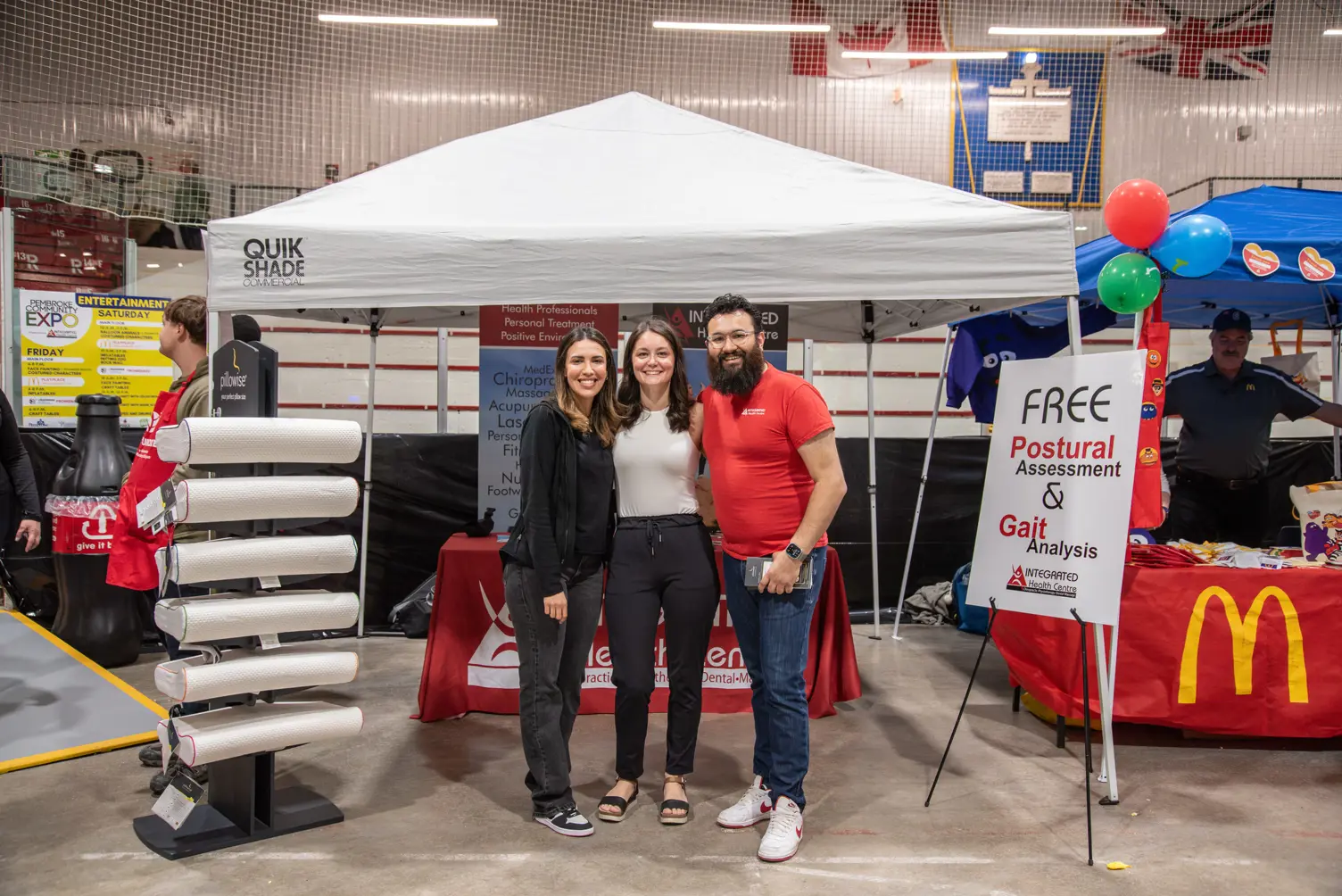 People in front of a vendor booth.