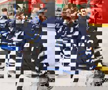 A young hockey player celebrates after a victory.