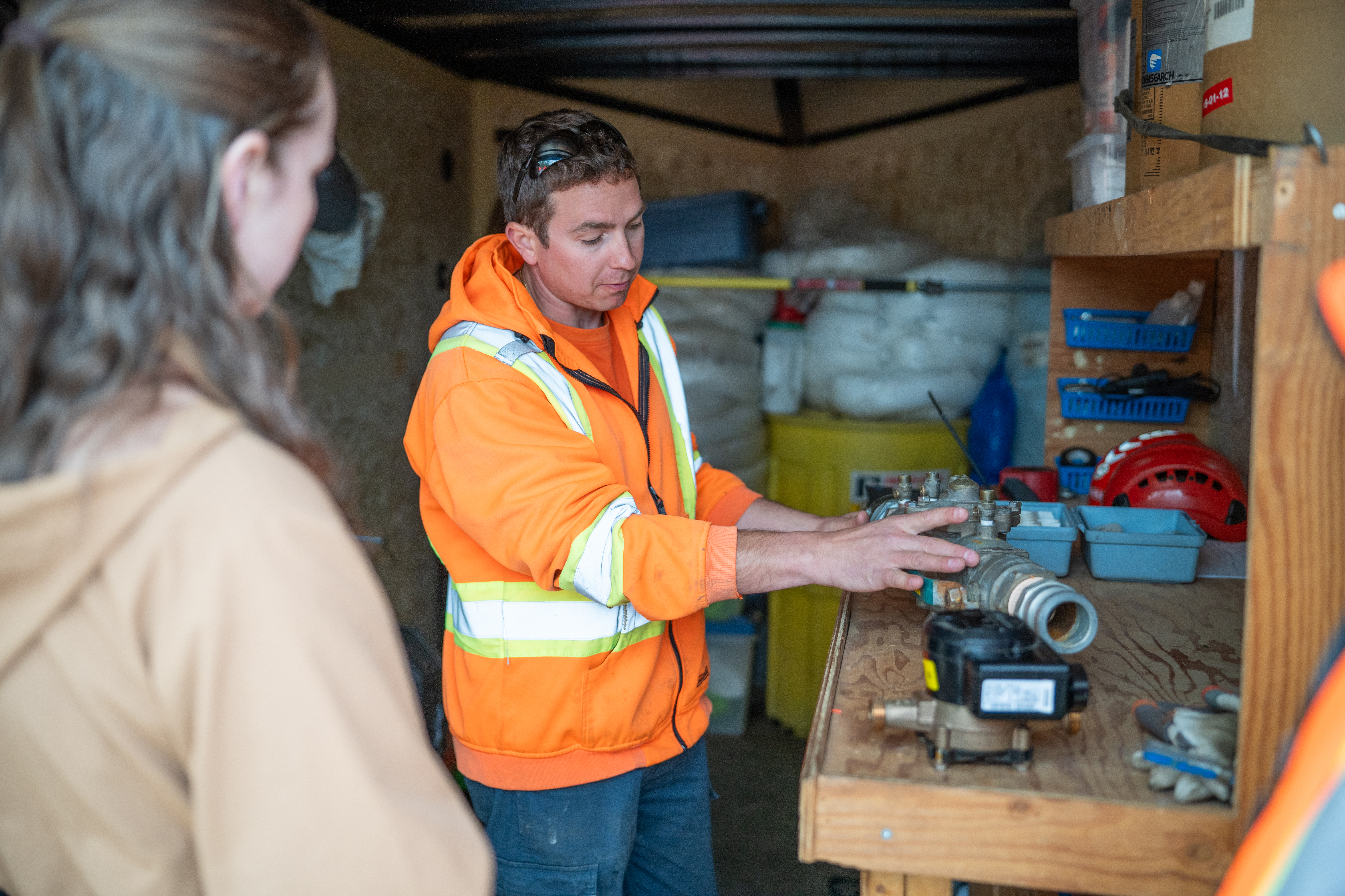 A worker explaining water equipment.
