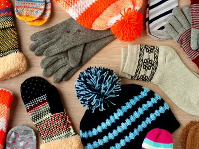 Winter hats, mitts, and socks spread out.