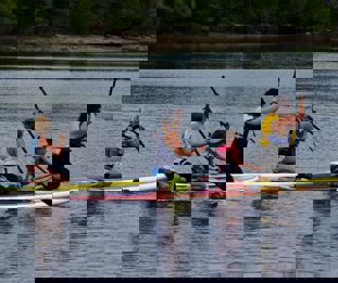 A family paddling on paddleboards.